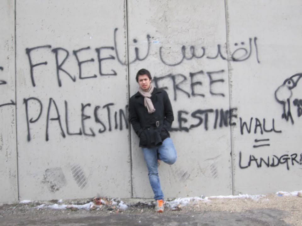 Charles Erickson in front of the separation wall in the West Bank, January 2013